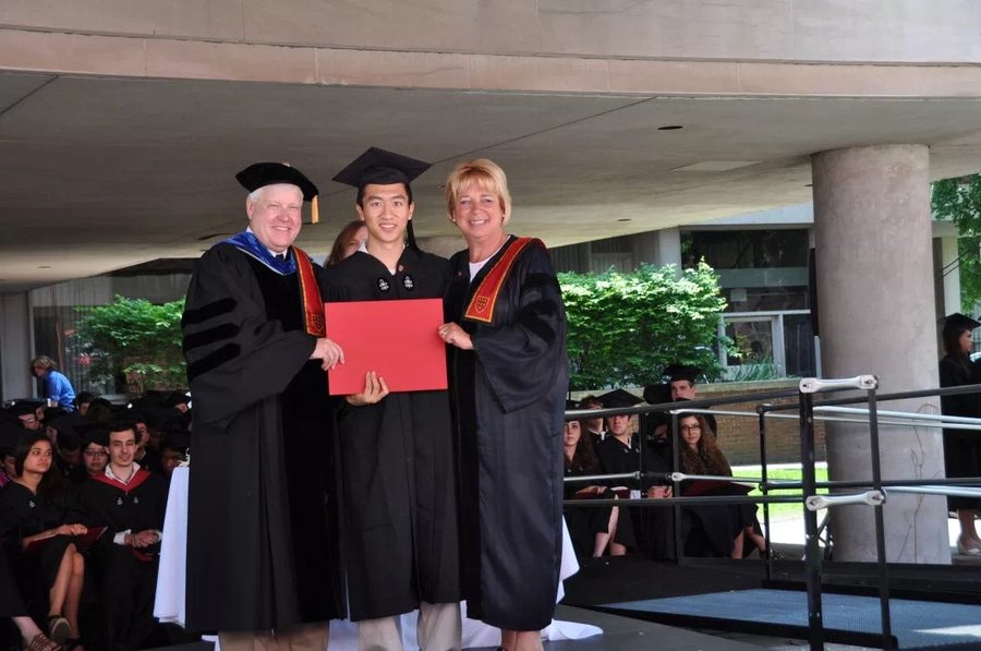 George receiving his Harvard diploma on stage