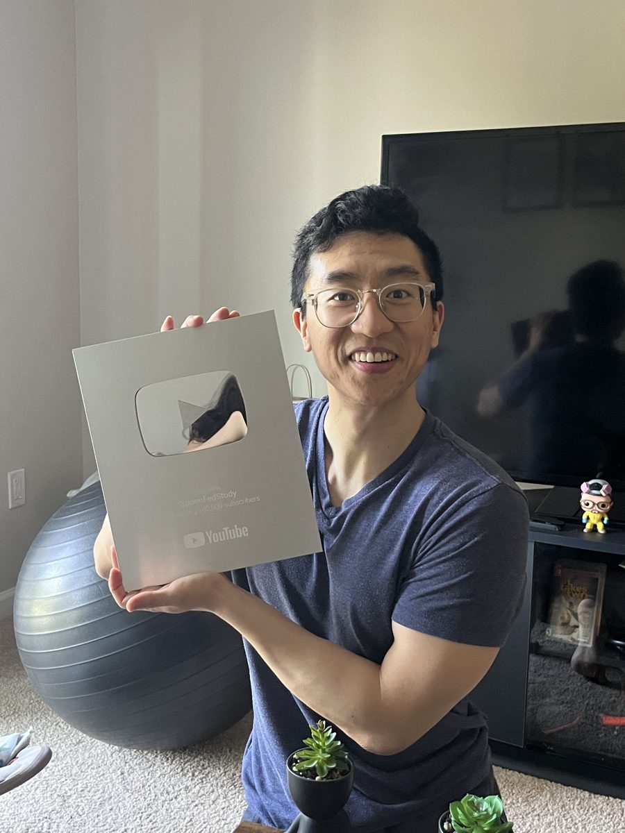 George holding the Silver Play Button award